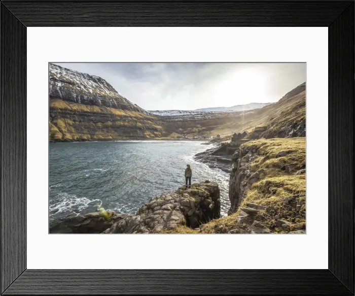 Framed Print : Girl standing along the fjord close to Tjornuvik. Streymoy island, Faroe islands Framed Print : Girl standing along the fjord close to Tjornuvik. Streymoy island, Faroe islands