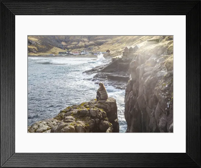 Framed Print : Girl sitting along the fjord close to Tjornuvik. Streymoy island, Faroe islands Framed Print : Girl sitting along the fjord close to Tjornuvik. Streymoy island, Faroe islands