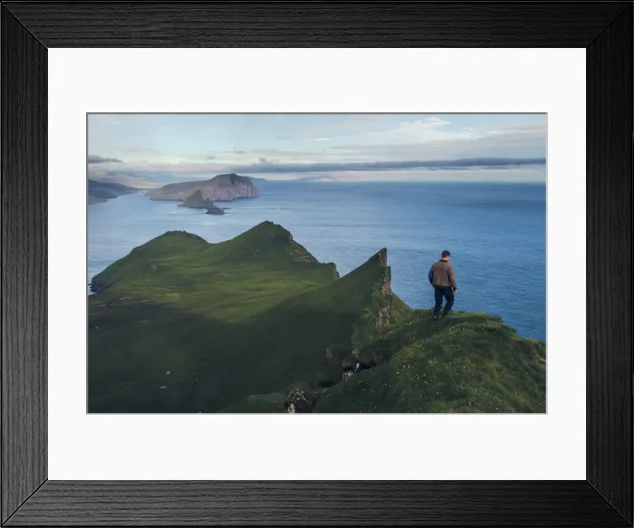 Framed Print : Faroese guy walking along Knukur mountain in Mykines. Faroe Islands Framed Print : Faroese guy walking along Knukur mountain in Mykines. Faroe Islands