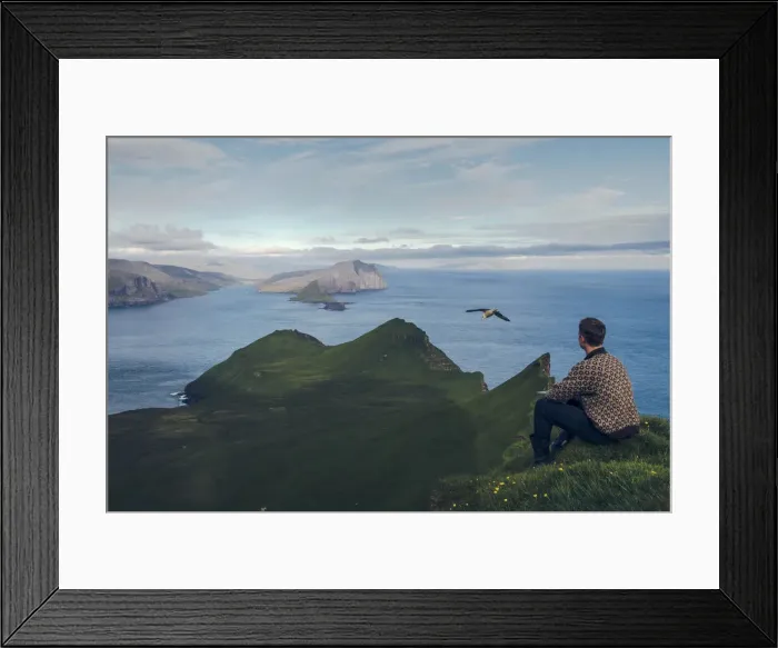 Framed Print : Faroese guy sitting along Knukur mountain in Mykines. Faroe Islands Framed Print : Faroese guy sitting along Knukur mountain in Mykines. Faroe Islands