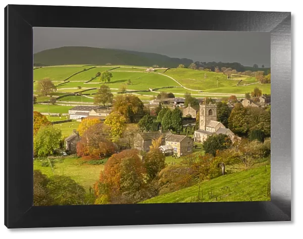 Autumn colours surround the picturesque Yorkshire Dales village of Burnsall, Wharfedale