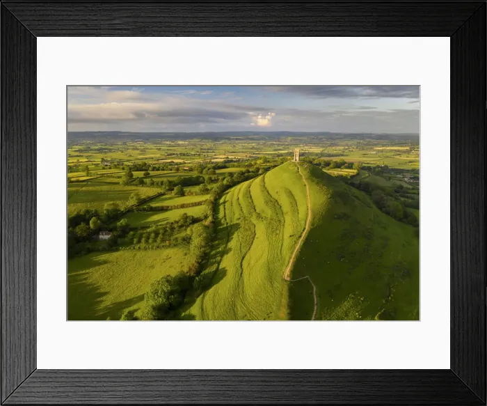 Framed Print : Aerial view of Glastonbury on a sunny summer evening, Somerset, England Framed Print : Aerial view of Glastonbury on a sunny summer evening, Somerset, England