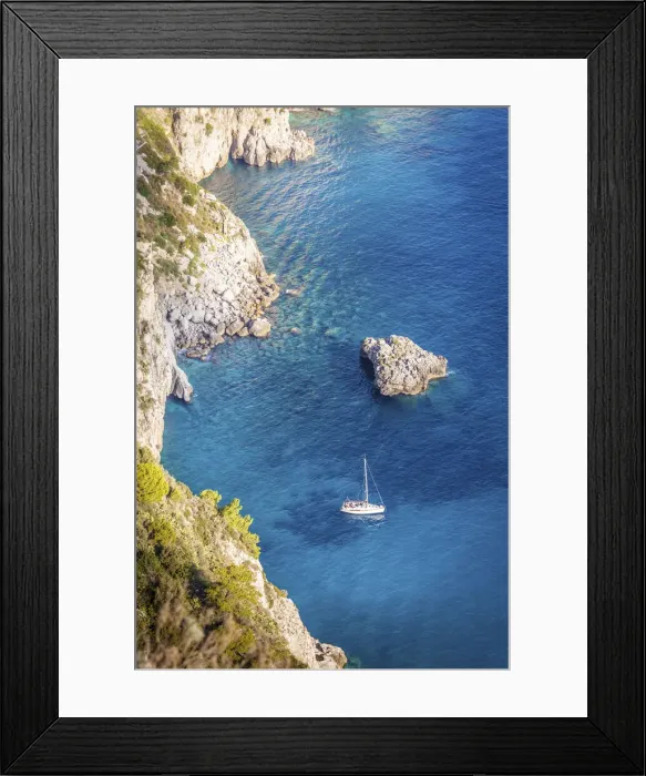 Framed Print : Sailboat in blue bay at the Faraglione rocks on Capri, Capri Island, Gulf of Naples Framed Print : Sailboat in blue bay at the Faraglione rocks on Capri, Capri Island, Gulf of Naples