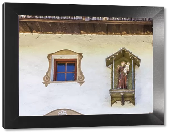 statue of St. Anthony on an old farmhouse in St. Magdalena in Villnoss Valley, South Tyrol, Italy
