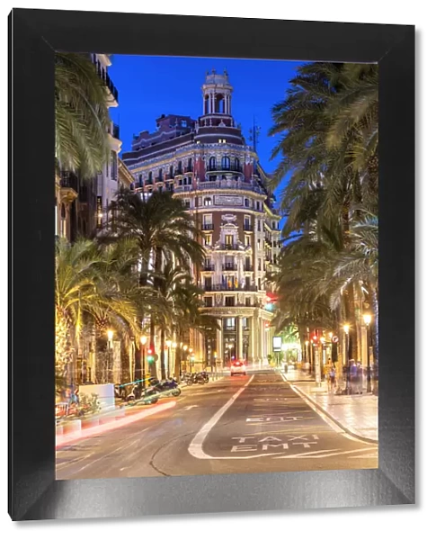 Twilight view of a street in the city center with the historical Banco de Valencia