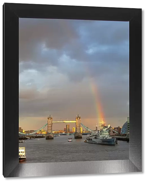 Tower Bridge and HMS Belfast from London Bridge at sunset with rainbow, London