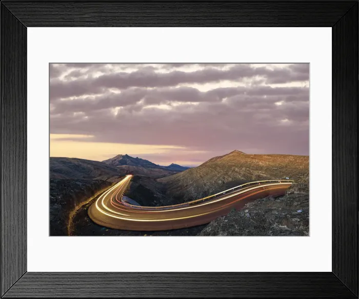 Framed Print : Car trails lights on road crossing the desert landscape at sunrise, Fuerteventura Framed Print : Car trails lights on road crossing the desert landscape at sunrise, Fuerteventura