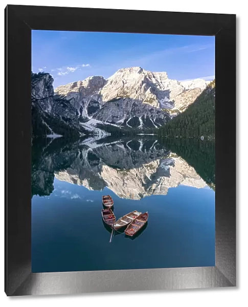 boats in lake Braies (Pragser Wildsee) and Croda del Becco reflected in water, Dolomites