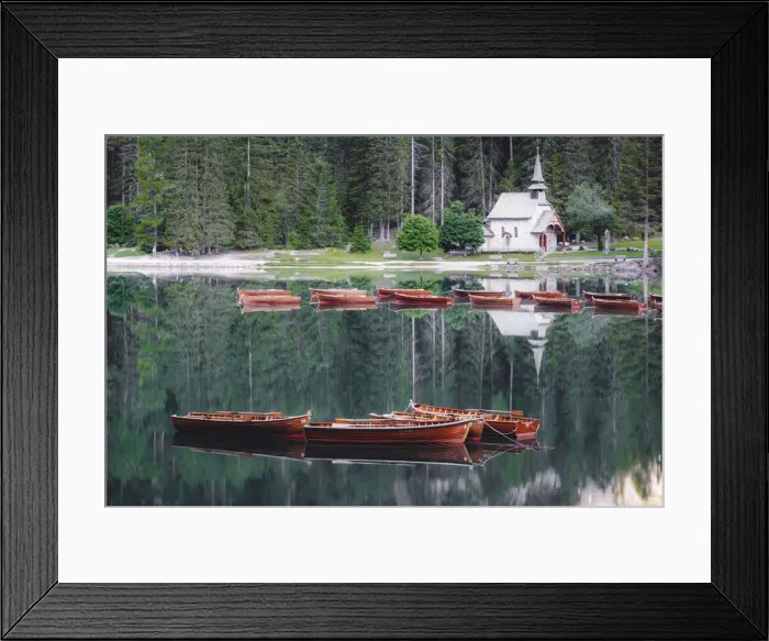 Framed Print : Boats in the pristine lake Braies (Pragser Wildsee) with the small chapel mirrored in