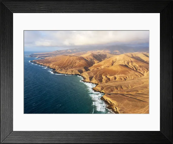 Framed Print : sunset over desert mountains and cliffs washed by ocean, Pajara, Fuerteventura Framed Print : sunset over desert mountains and cliffs washed by ocean, Pajara, Fuerteventura