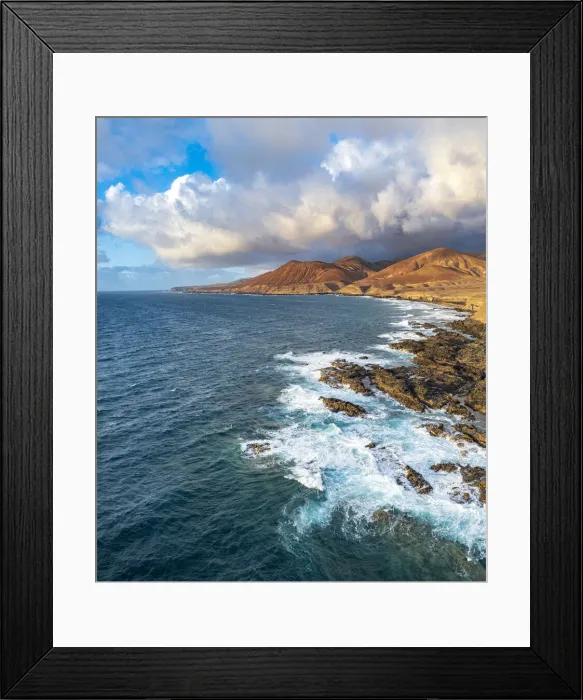 Framed Print : Clouds at sunset on breaking waves at Playa de la Solapa beach, aerial view, Pajara
