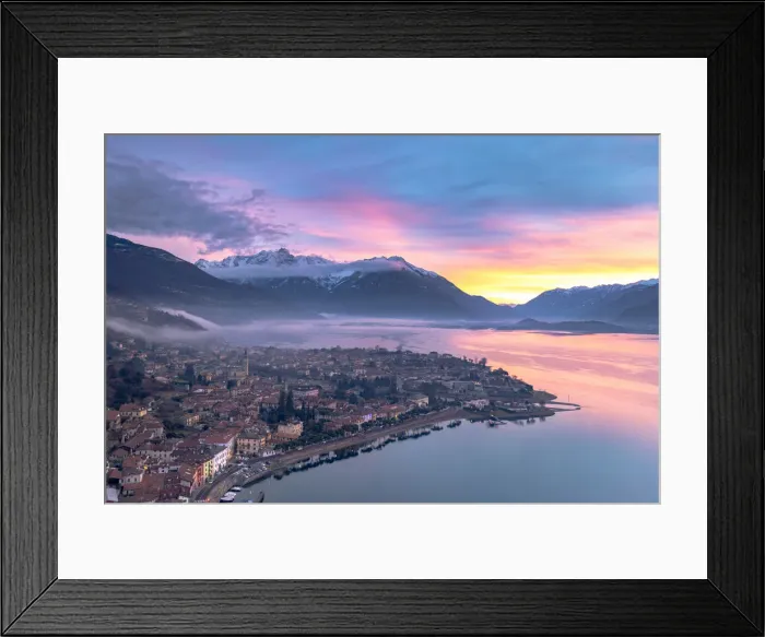 Framed Print : Burning sky at dawn over the snowcapped mountains and Domaso old town, aerial view Framed Print : Burning sky at dawn over the snowcapped mountains and Domaso old town, aerial view