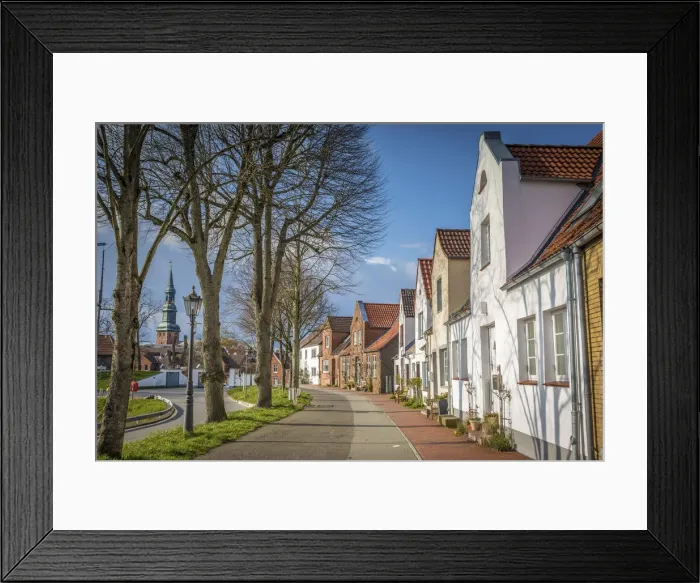 Framed Print : Street at the harbor in Toenning with St. Laurentius Church, North Friesland