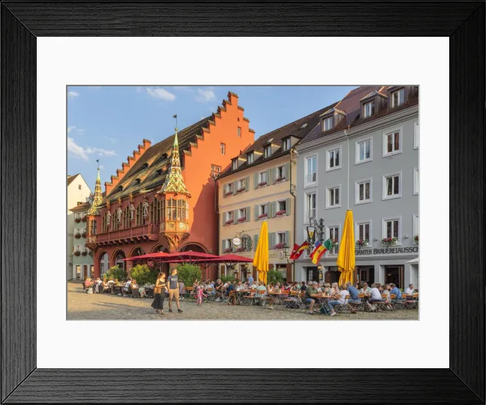 Framed Print : Restaurants near historischen Kaufhaus (historical Merchant's Hall) on Munsterplatz Square, Freiburg im Breisgau, Black Forest, Baden-Wurttemberg, Germany Framed Print : Restaurants near historischen Kaufhaus (historical Merchant's Hall) on Munsterplatz Square, Freiburg im Breisgau, Black Forest, Baden-Wurttemberg, Germany