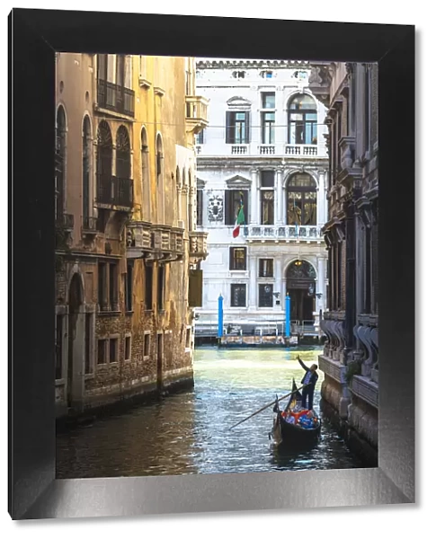 Venice, Veneto, Italy. Gondola rowing among historical palaces