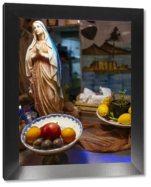 Statuette of the Madonna in a typical restaurant, Naples, Italy