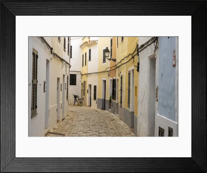 Framed Print : Colourful buildings line a narrow street in the old town of Ciutadella, Ciudadela Framed Print : Colourful buildings line a narrow street in the old town of Ciutadella, Ciudadela