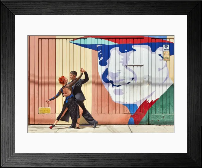 Framed Print : Professional Tango Dancers in front of a wall art of the historical tango artist Carlos Gardel in the Abasto neighborhood, Buenos Aires, Argentina. (MR) Framed Print : Professional Tango Dancers in front of a wall art of the historical tango artist Carlos Gardel in the Abasto neighborhood, Buenos Aires, Argentina. (MR)