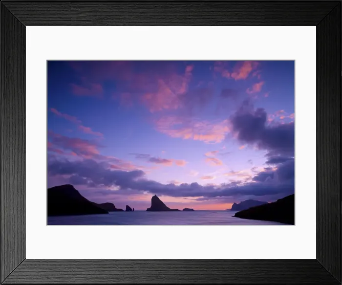 Framed Print : A colorful sunset seen from the village of Sorvagur (island of Vagar). In the background Drangarnir seastacks, Tindholmur islet and the island of Mykines. Faroe Islands Framed Print : A colorful sunset seen from the village of Sorvagur (island of Vagar). In the background Drangarnir seastacks, Tindholmur islet and the island of Mykines. Faroe Islands