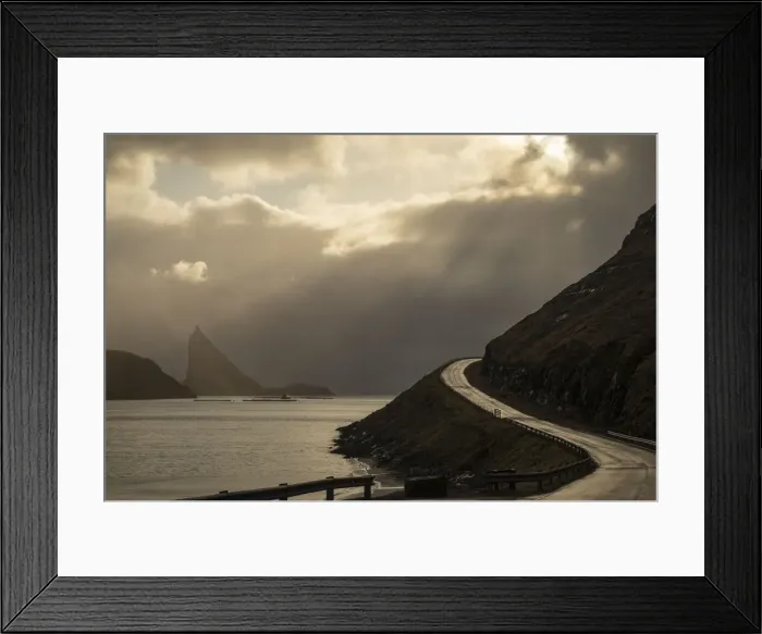 Framed Print : Scenic road in the island of Vagar. In the background the islet of Tindholmur. Faroe Islands