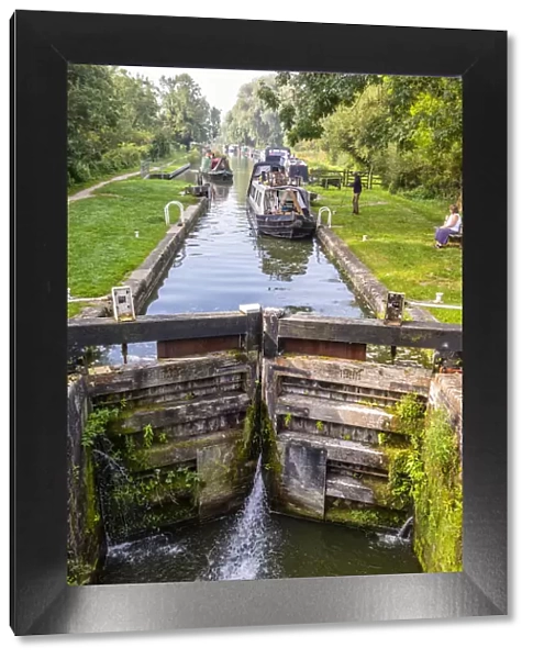 Boats going through a lock in Great Bedwyn, Marlborough, Wiltshire, England, United Kingdom