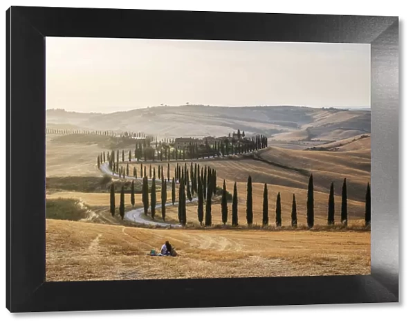 A loving couple found the perfect pic-nic spot: the fields in front of the Agriturismo Baccoleno, in the heart of the Crete Senesi, with all the rolling hills around. Tuscany, Italy