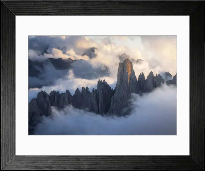 Framed Print : The Cadini di Misurina emerging from the sea of clouds during a stormy late summer sunset. Dolomites, Italy Framed Print : The Cadini di Misurina emerging from the sea of clouds during a stormy late summer sunset. Dolomites, Italy