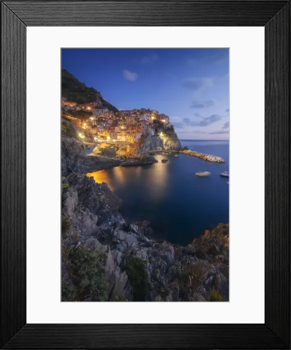 Framed Print : Twilight in Manarola, Cinque Terre, the most beautiful moment of the day when the lights of the town come Framed Print : Twilight in Manarola, Cinque Terre, the most beautiful moment of the day when the lights of the town come