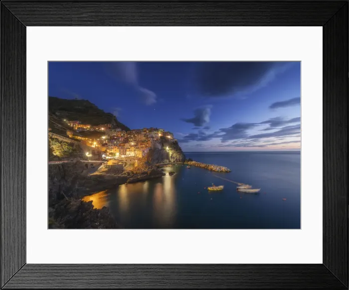 Framed Print : Twilight in Manarola, Cinque Terre, the most beautiful moment of the day when the lights of the town come
