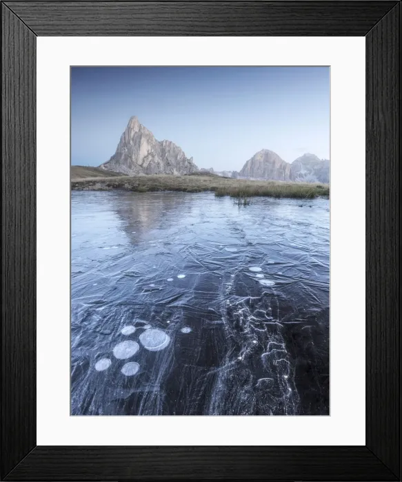 Framed Print : A frozen puddle near the Giau Pass in the Dolomites provides a cool foreground during a freezing autumn morning, with the Ra Gusela and Tofane reflecting on it Framed Print : A frozen puddle near the Giau Pass in the Dolomites provides a cool foreground during a freezing autumn morning, with the Ra Gusela and Tofane reflecting on it