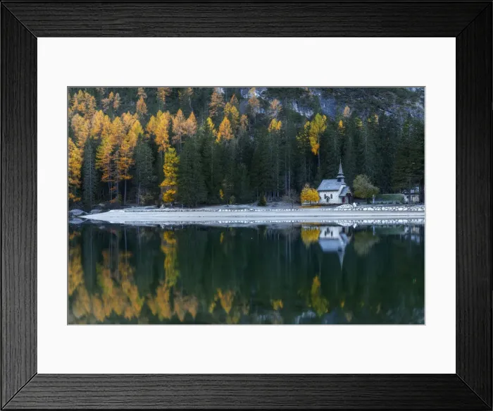 Framed Print : The small chapel on the shores of the Braies lake (Pragser Wildsee) with larches and firs reflecting in the lake. Dolomites, Italy Framed Print : The small chapel on the shores of the Braies lake (Pragser Wildsee) with larches and firs reflecting in the lake. Dolomites, Italy