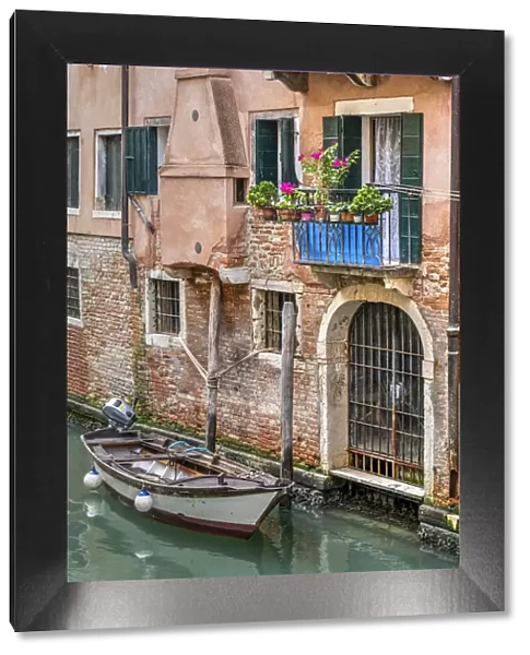 Scenic water canal with moored boat, Venice, Veneto, Italy