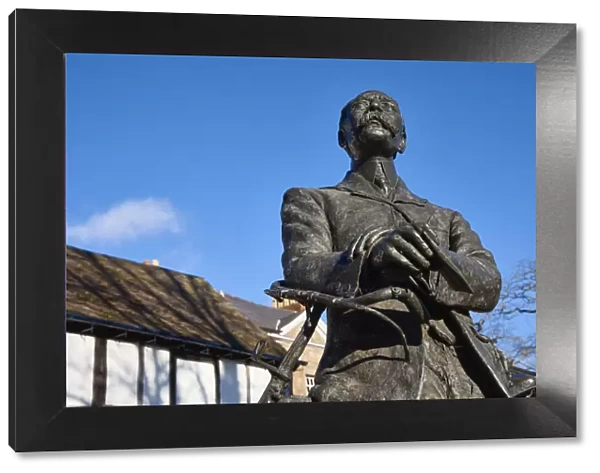 UK, England, Herefordshire, Hereford, Edward Elgar Statue leaning against a bicycle infront of Cathedral barn