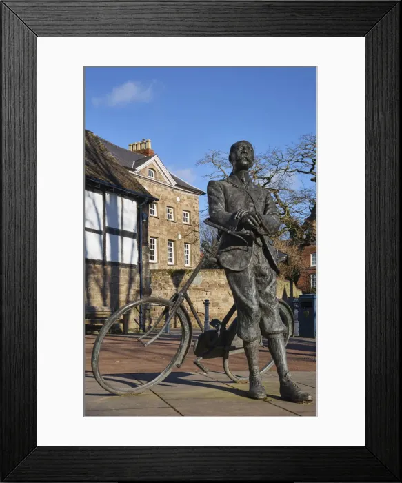 Framed Print : UK, England, Herefordshire, Hereford, Edward Elgar Statue leaning against his Sunbeam bicycle infront of Cathedral barn Framed Print : UK, England, Herefordshire, Hereford, Edward Elgar Statue leaning against his Sunbeam bicycle infront of Cathedral barn