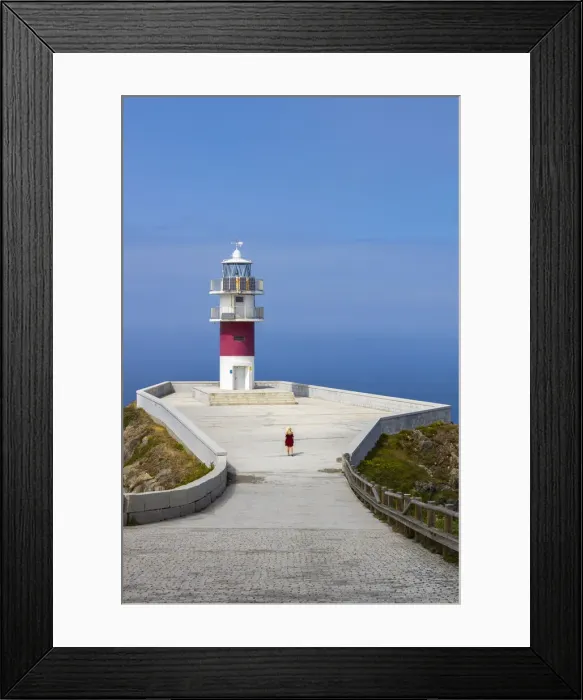 Framed Print : Woman at Cabo Ortegal and its lighthouse at sunrise, Galicia, Spain (MR) Framed Print : Woman at Cabo Ortegal and its lighthouse at sunrise, Galicia, Spain (MR)