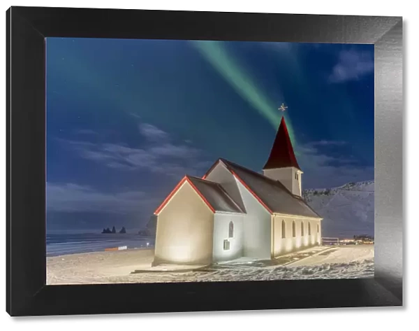 Europe, Iceland, Vik y Myrdal: the magic green of the Northern Lights over the Church and the rock pillars