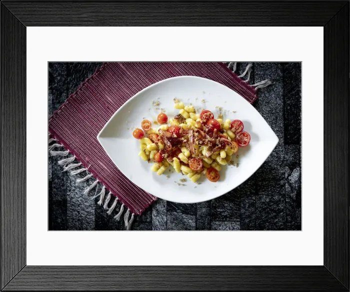 Framed Print : Gnocchi with bacon and small tomatoes on rustic placemat, Italy Framed Print : Gnocchi with bacon and small tomatoes on rustic placemat, Italy