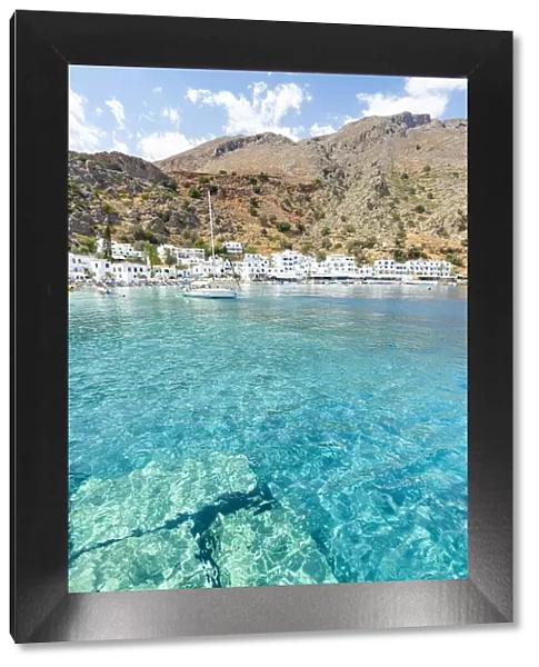 Sail boat in the turquoise crystal sea surrounding Loutro village, Crete island, Greece