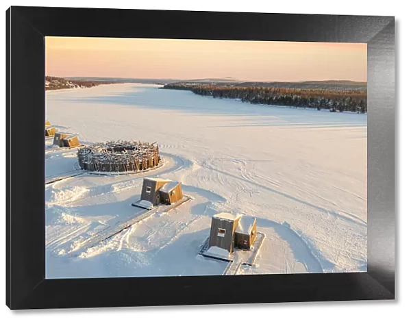 Arctic Bath Hotel and its wood cabins in the snow at sunset, Harads, Lapland, Sweden