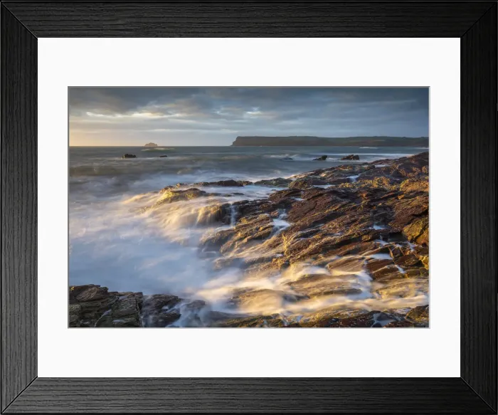 Framed Print : Waves crash over sun drenched rocks near Polzeath on the North Coast of Cornwall, England. Summer (August) 2021 Framed Print : Waves crash over sun drenched rocks near Polzeath on the North Coast of Cornwall, England. Summer (August) 2021