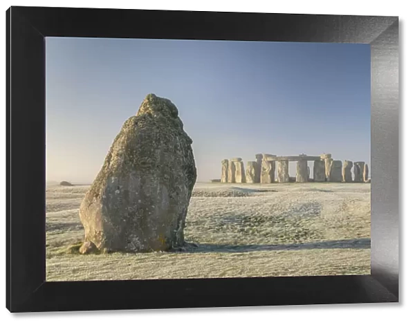 Stonehenge and the Heel Stone at dawn on a chill frosty winter morning, Wiltshire, England. Winter (January) 2022