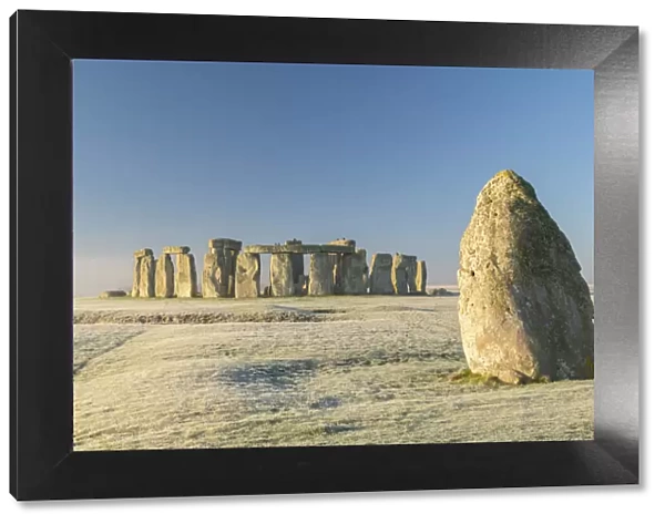 Stonehenge and the Heel Stone at dawn on a chill frosty winter morning, Wiltshire, England. Winter (January) 2022