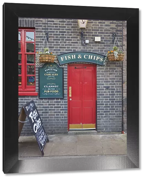 A signboard saying 'Fish & Chips'over the door of the 'Anchor Bankside'traditional pub, Bankside, London, United Kingdom
