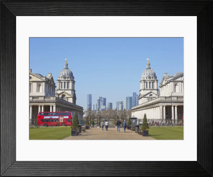 Framed Print : A traditional double-decker red bus passing by the Greenwich University at the Old Royal Naval College with the Canary Wharf skyline in background, London, United Kingdom, Northern Europe Framed Print : A traditional double-decker red bus passing by the Greenwich University at the Old Royal Naval College with the Canary Wharf skyline in background, London, United Kingdom, Northern Europe