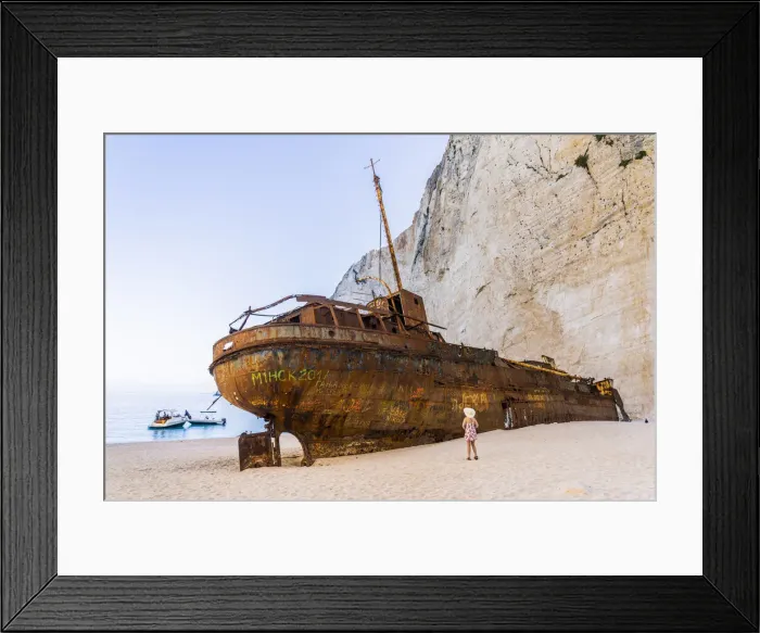 Framed Print : A girl in a hat looking at the shipwreck on Navagio Beach or Shipwreck Beach, Zakynthos, Zante, Ionian Islands, Greece Framed Print : A girl in a hat looking at the shipwreck on Navagio Beach or Shipwreck Beach, Zakynthos, Zante, Ionian Islands, Greece