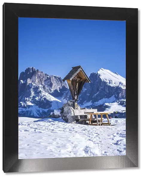 Dolomites Alps, snow landscape with clear blue sky. pic nic bench, mountains in background