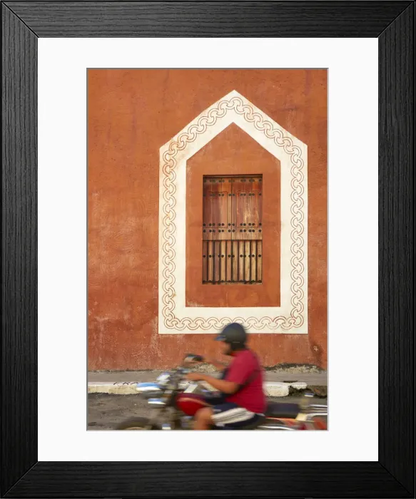 Framed Print : A motorcycle passes in front of a window of a colonial house in Valladolid, Yucatan, Mexico Framed Print : A motorcycle passes in front of a window of a colonial house in Valladolid, Yucatan, Mexico