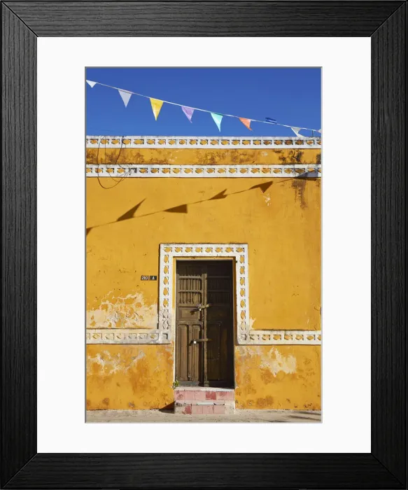 Framed Print : The front facade of a colonial house in Izamal, Yucatan, Mexico Framed Print : The front facade of a colonial house in Izamal, Yucatan, Mexico