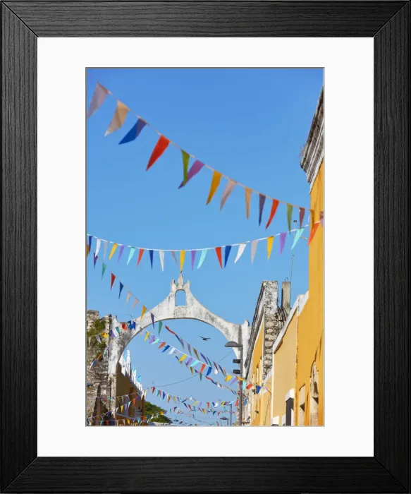 Framed Print : The white arch in colonial architecture of Izamal with colorful flags, Yucatan, Mexico. Izamal is known in Yucatan as the Yellow City, as most of its buildings are painted yellow Framed Print : The white arch in colonial architecture of Izamal with colorful flags, Yucatan, Mexico. Izamal is known in Yucatan as the Yellow City, as most of its buildings are painted yellow