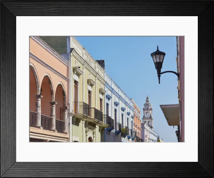 Framed Print : Colorful houses in colonial architecture on a street in the historic center of Campeche with the cathedral in the background, Yucatan, Mexico Framed Print : Colorful houses in colonial architecture on a street in the historic center of Campeche with the cathedral in the background, Yucatan, Mexico